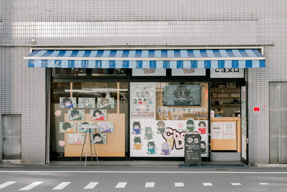 Anime-themed storefront with colorful characters and striped awning.