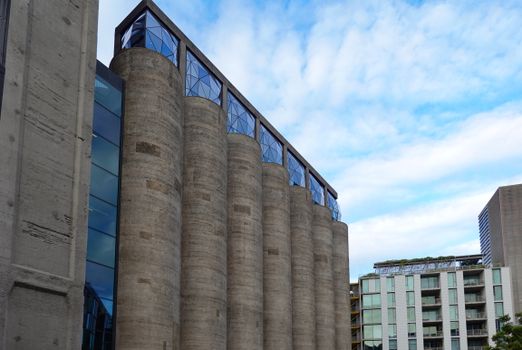 Innovative building design featuring vertical silo structures in an urban setting.