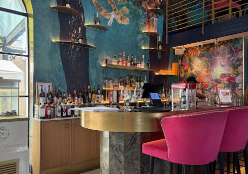 A colorful and stylish bar interior with eclectic decor and a lively ambiance.