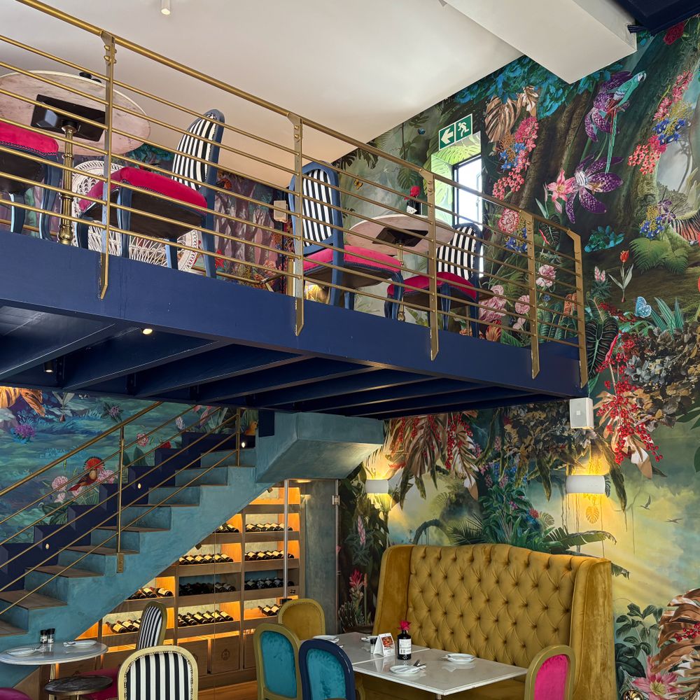 Wallpapering in Elephant and Castle — careful masking before painting begins