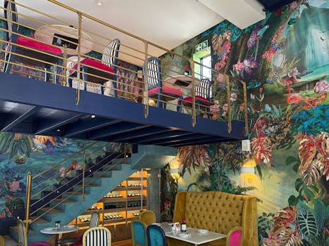 A colorful restaurant interior with vibrant decor and mezzanine seating area.