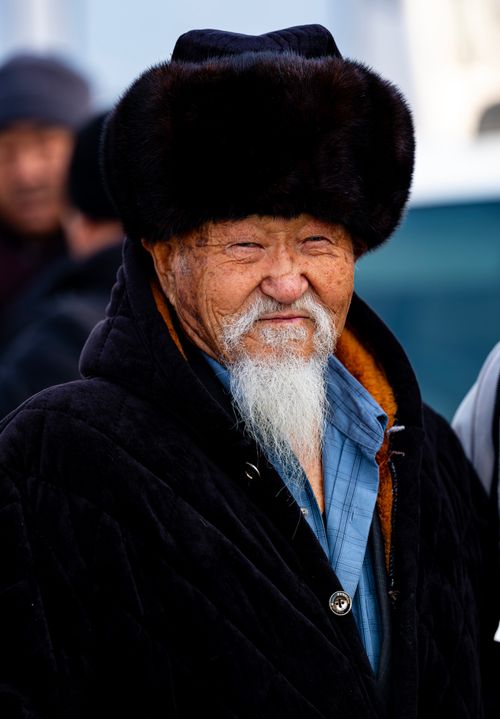 Free Portrait of an elderly man in traditional Kyrgyz winter attire, Bishkek, Kyrgyzstan. Stock Photo