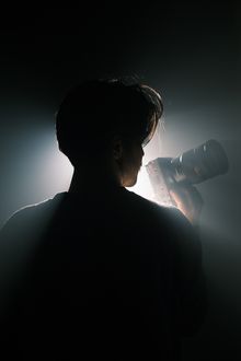 Silhouette of a photographer holding a camera, photo by Cemrecan Yurtman on Pexels