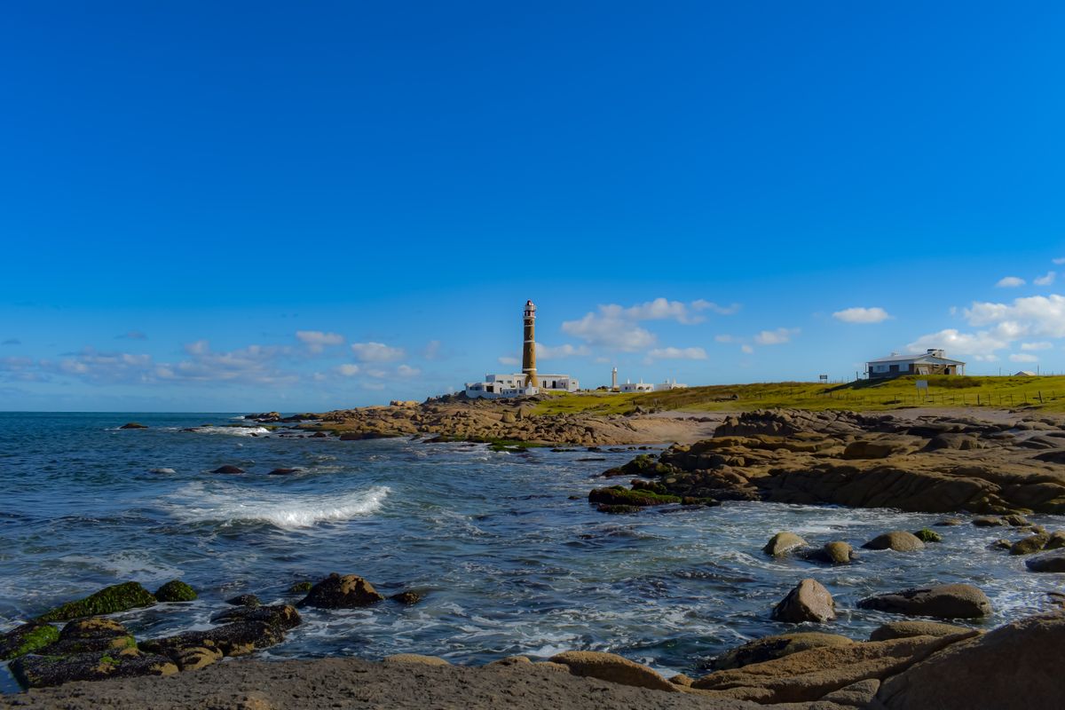 Cabo Polonio lighthouse above the rocky Atlantic shoreline, Uruguay