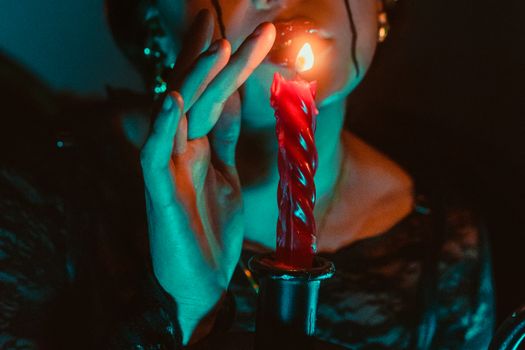 An atmospheric portrait featuring a person and a lit candle, casting shadows and a gothic vibe.