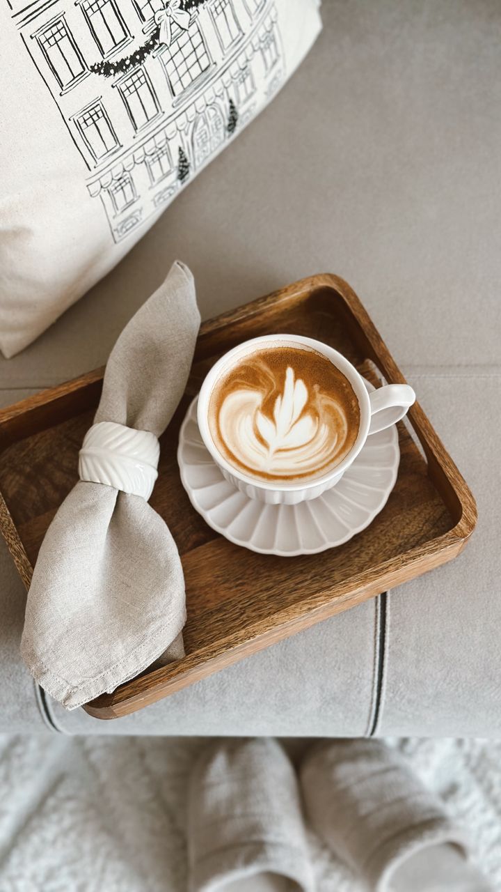Stack of neutral linen napkins placed on a coffee bar hutch shelf
