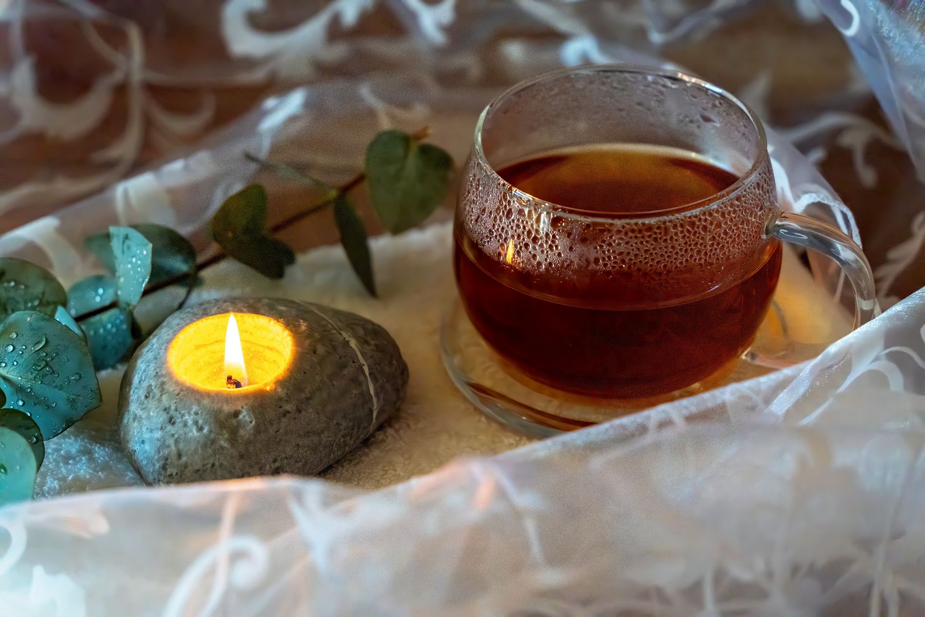 A calming tea, candle and eucalyptus self-care ritual