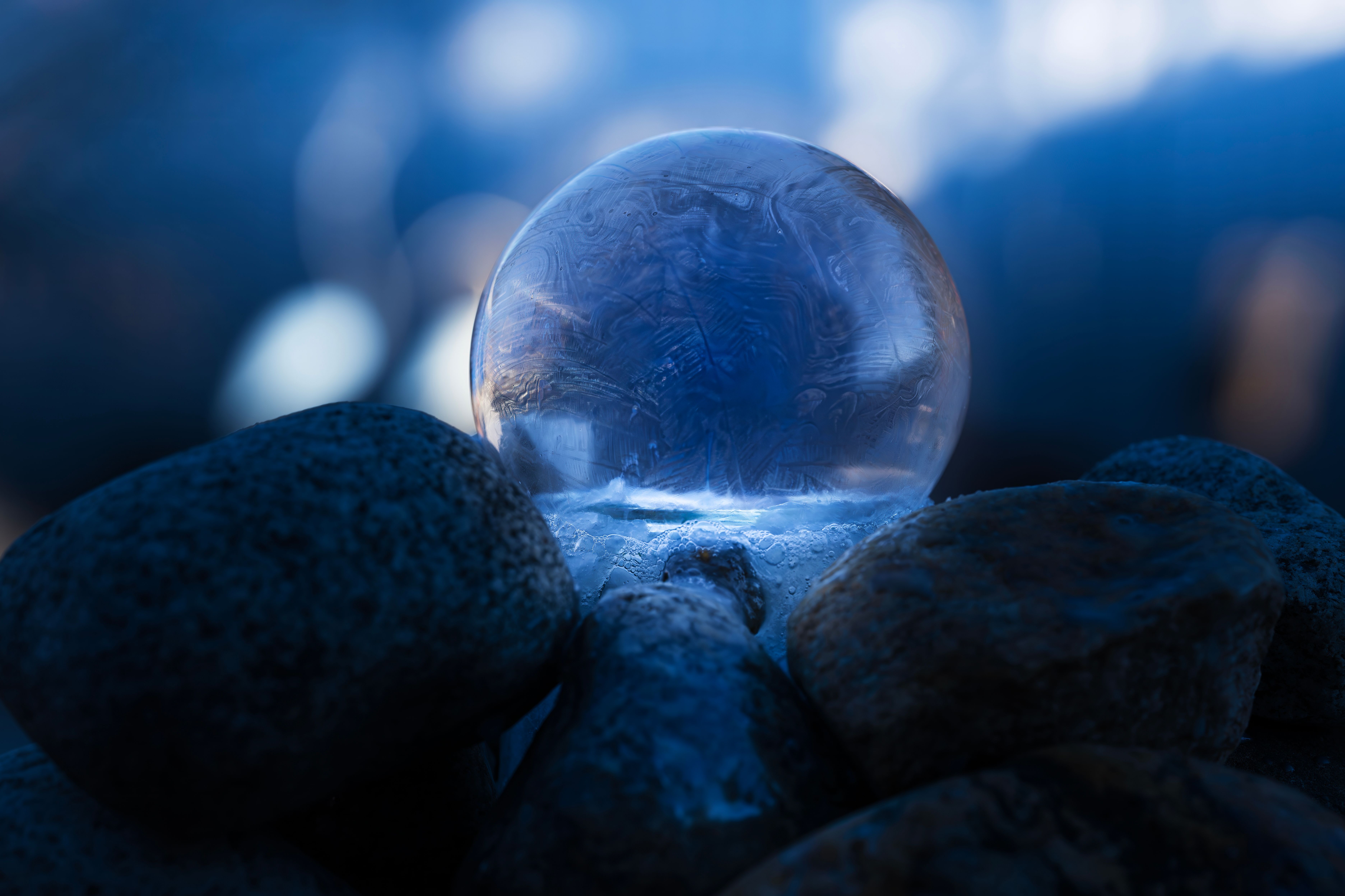Close-up of Frozen Soap Bubble on Rocks · Free Stock Photo