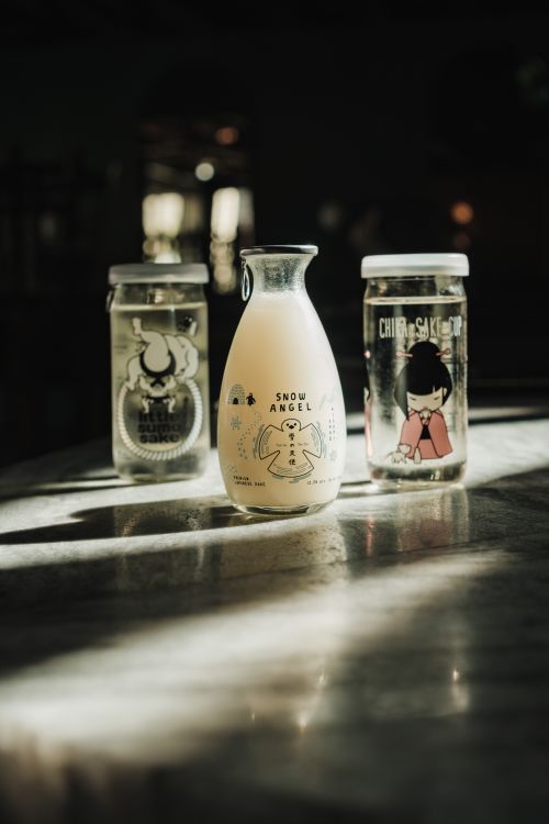 Free A creative still life of Japanese nigori sake jars with unique, artistic designs under soft lighting. Stock Photo