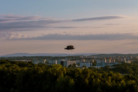 Aerial view of Kraków showcasing lush greenery and urban skyline during sunset.