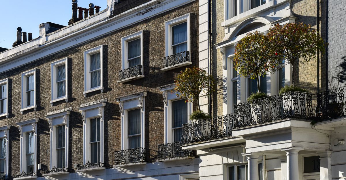 Elegant London townhouses with ornate balconies and lush greenery.