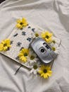 Vintage Camera on Open Journal with Daisies