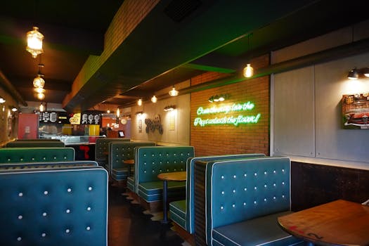Interior of a retro-style diner in Casablanca with teal booths and neon lighting.