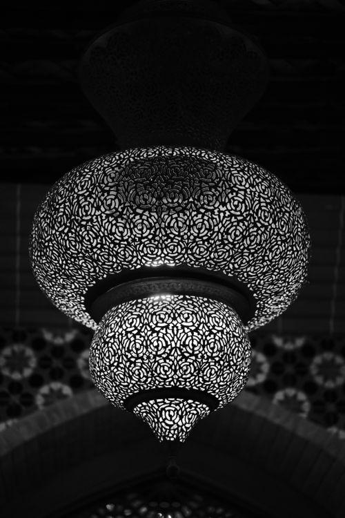 Free Monochromatic Arabic lamp with intricate designs in an indoor setting, capturing cultural essence. Stock Photo