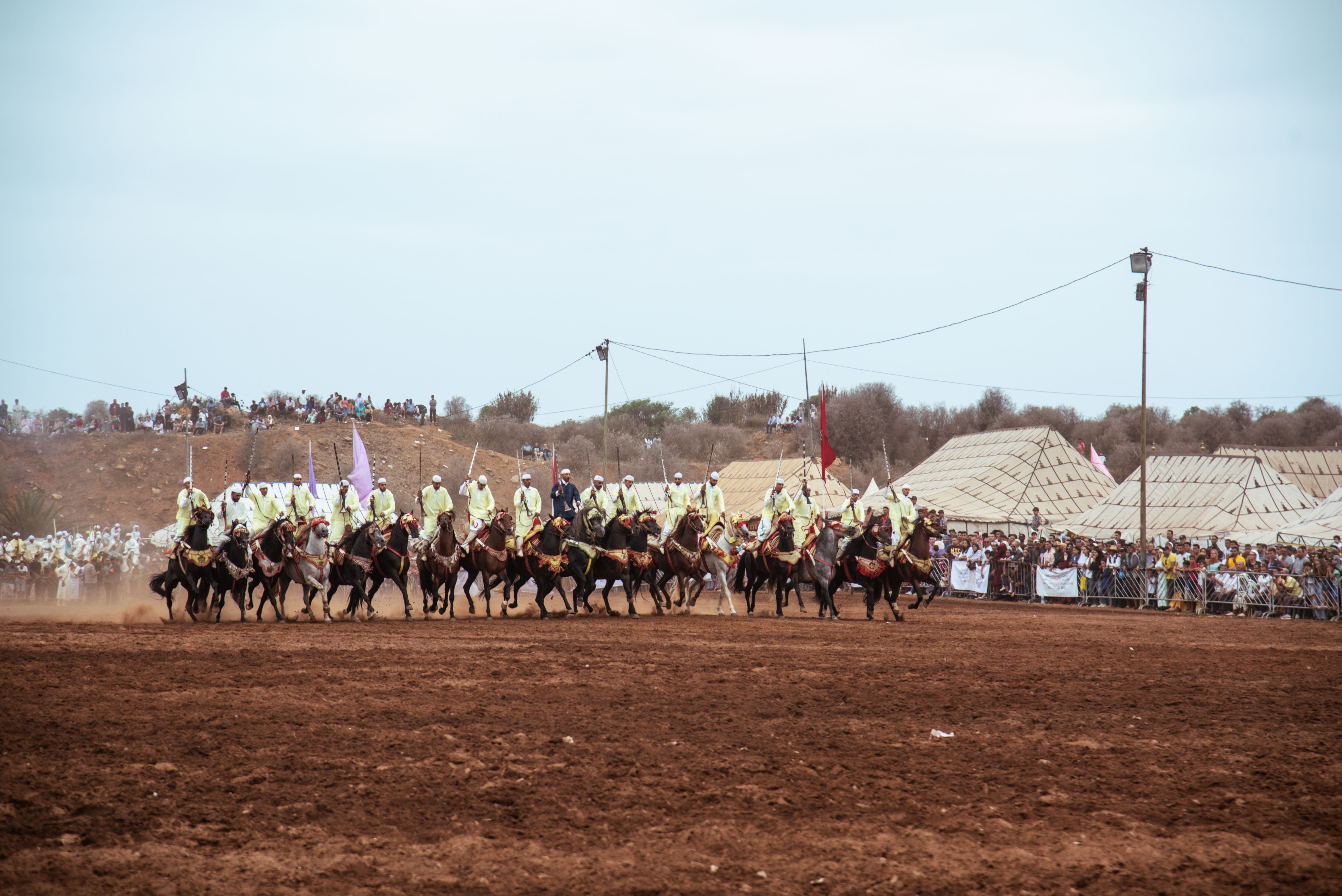 Moroccan horsemen perform at a vibrant Fantasia event in Rabat, showcasing equestrian skills.