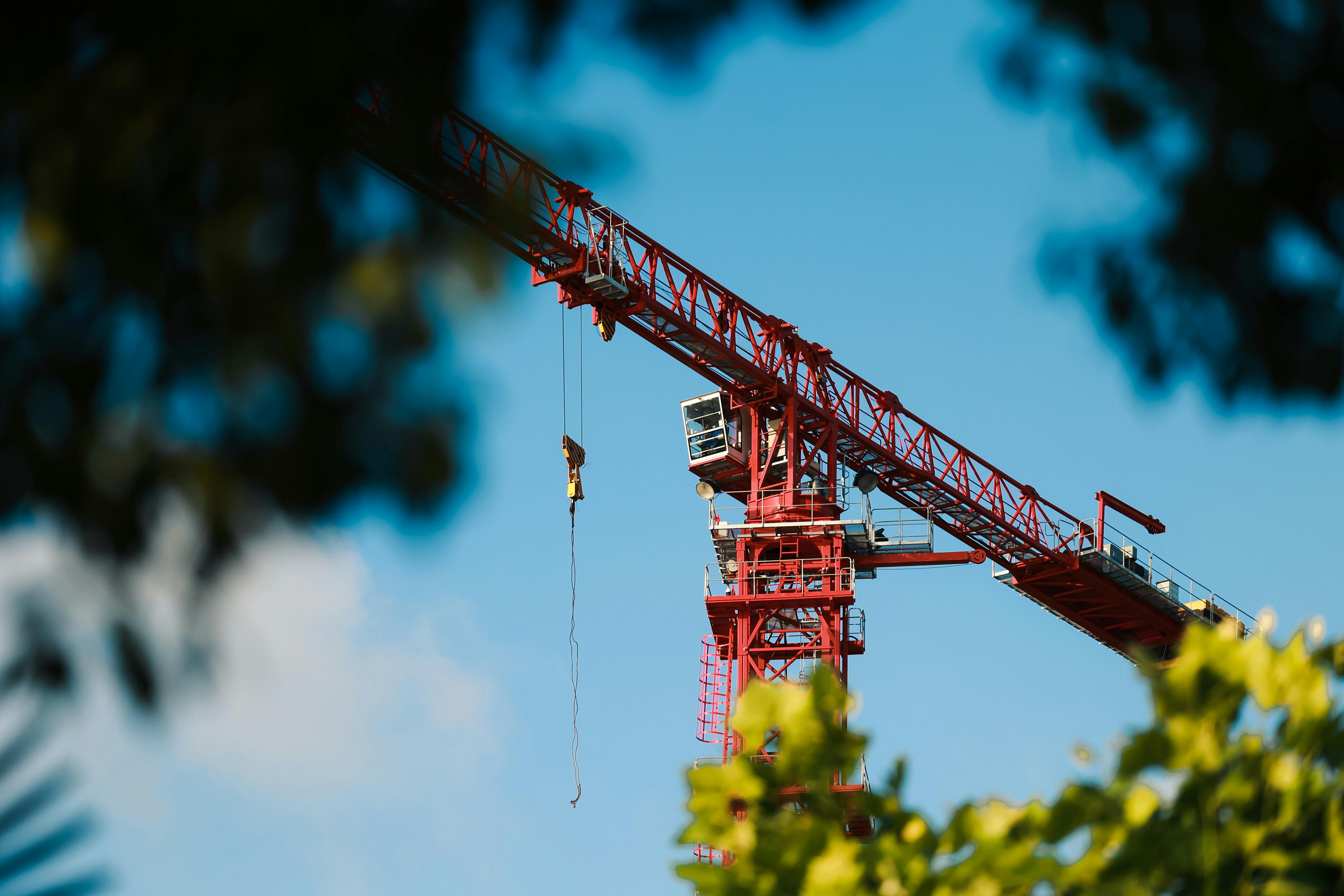 Tower Cranes Under Cloudy Sky · Free Stock Photo