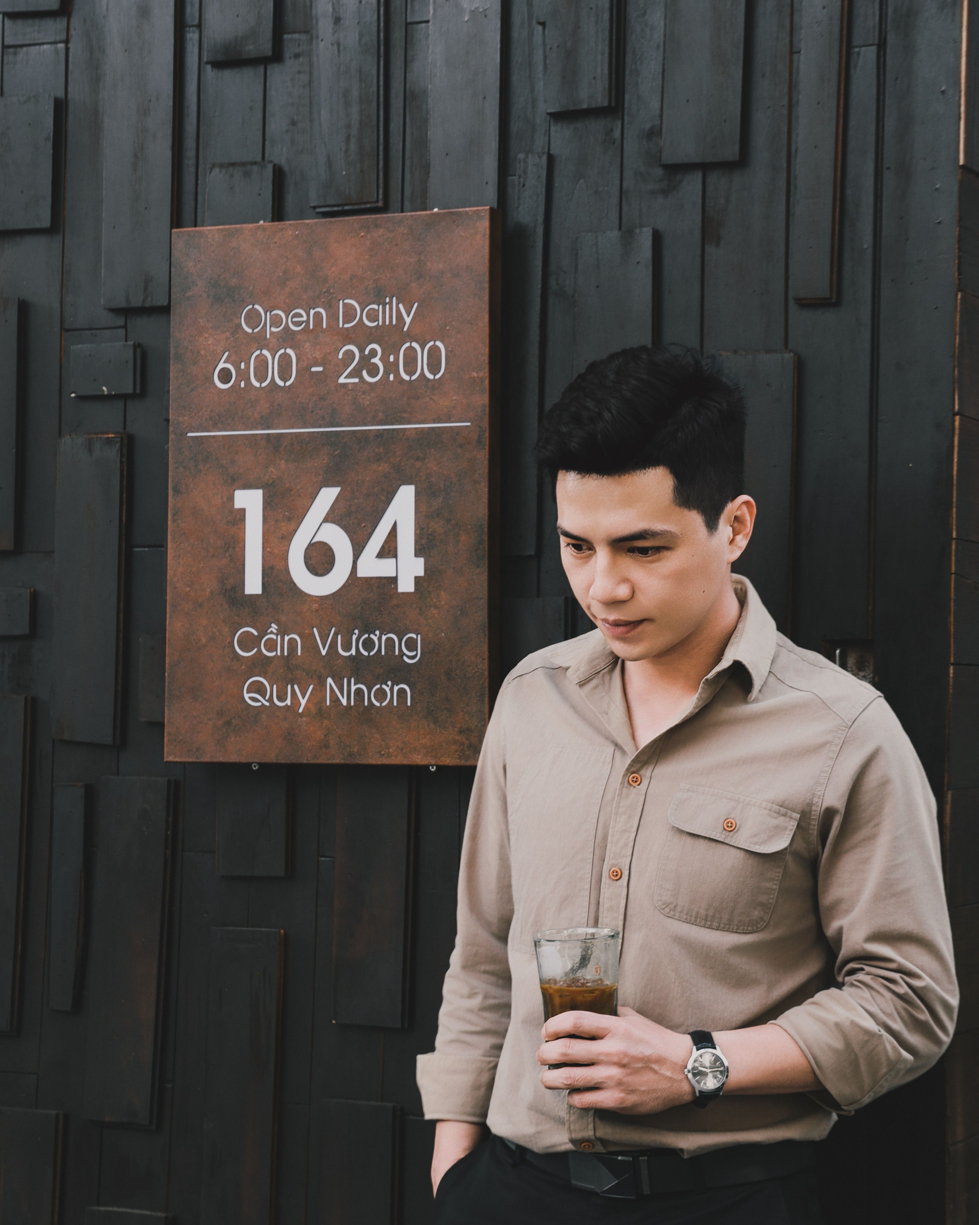 Young man with a drink outside a restaurant in Quy Nhon, Vietnam.