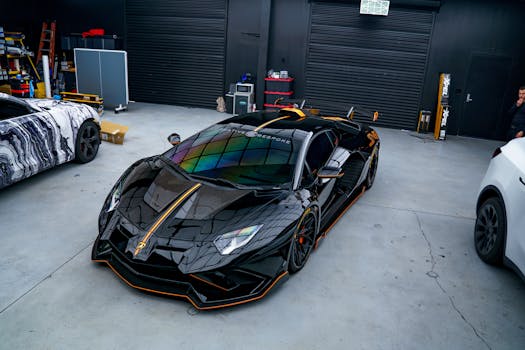 Sleek black sports car parked in a contemporary garage, showcasing luxury design.