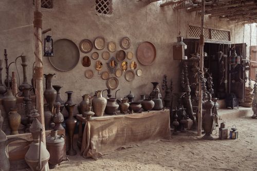 Free Rustic pottery shop with Middle Eastern artifacts and decor in a dimly lit indoor setting. Stock Photo