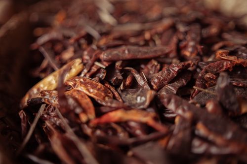 Free A detailed view of dried red chili peppers, showcasing texture and rich earthy tones. Stock Photo