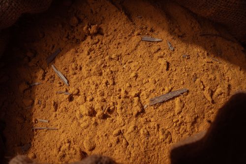Free Detailed image of ground turmeric spice in a burlap sack with natural lighting. Stock Photo