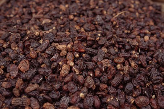 High angle view of a pile of dried raisins, showcasing their texture and rich color.