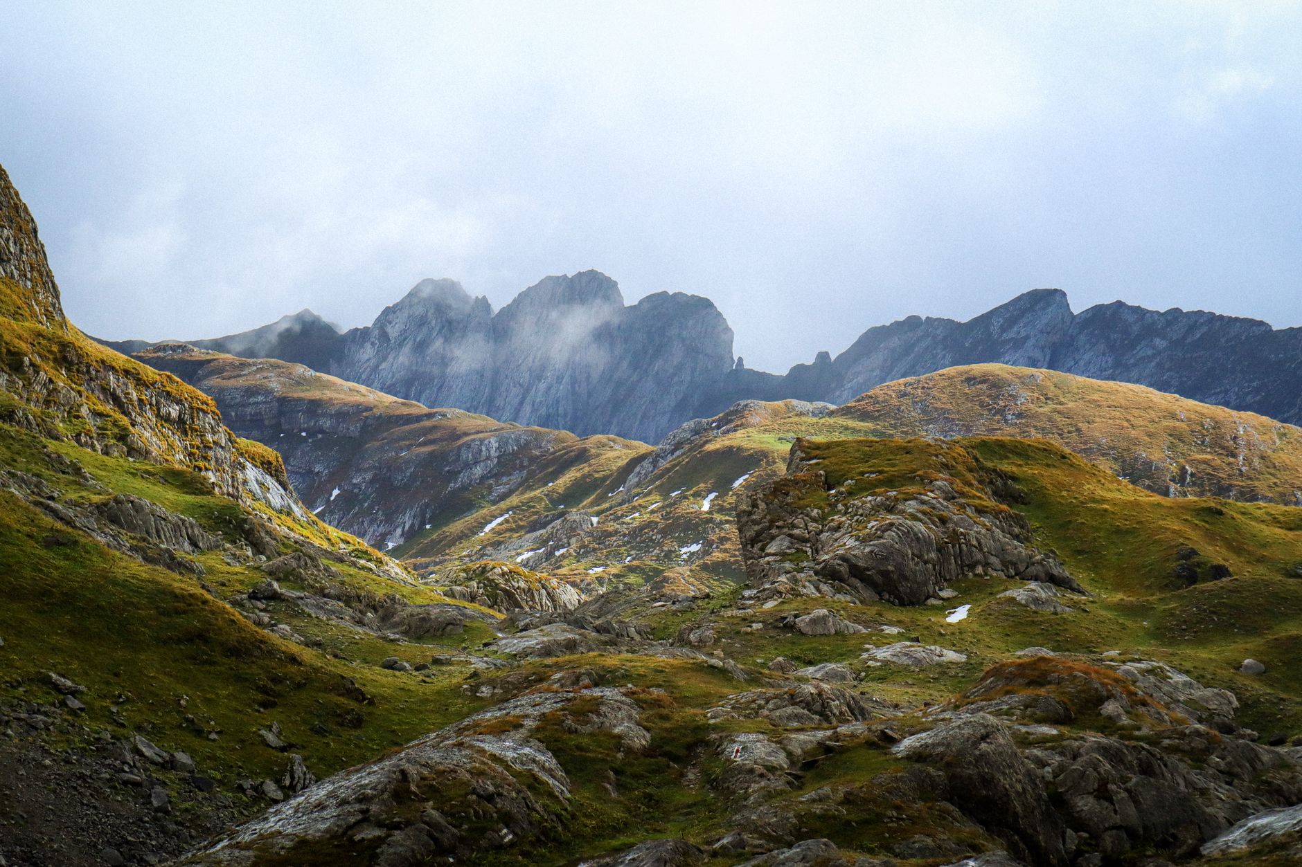 Majestic view of the Swiss Alps with rugged terrain and cloudy sky.