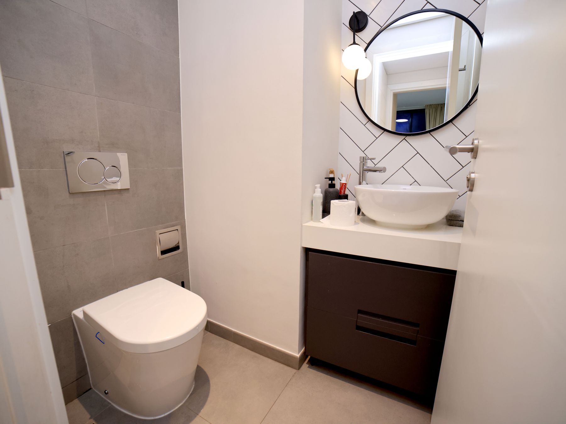 Compact minimalist bathroom with tightly coordinated fixtures and a simple repeatable layout