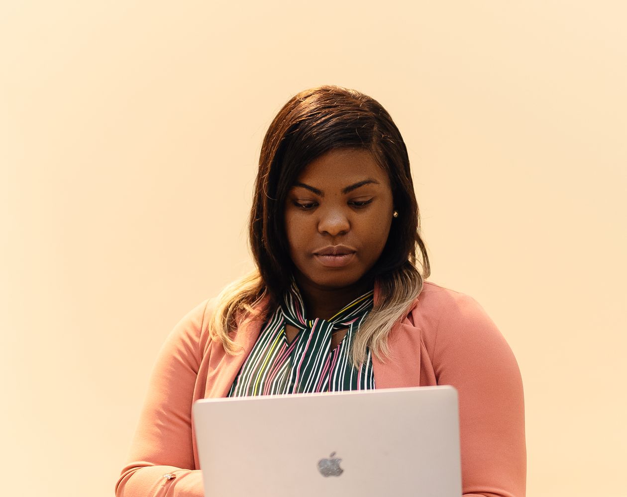 African businesswoman working securely on a laptop in a professional office