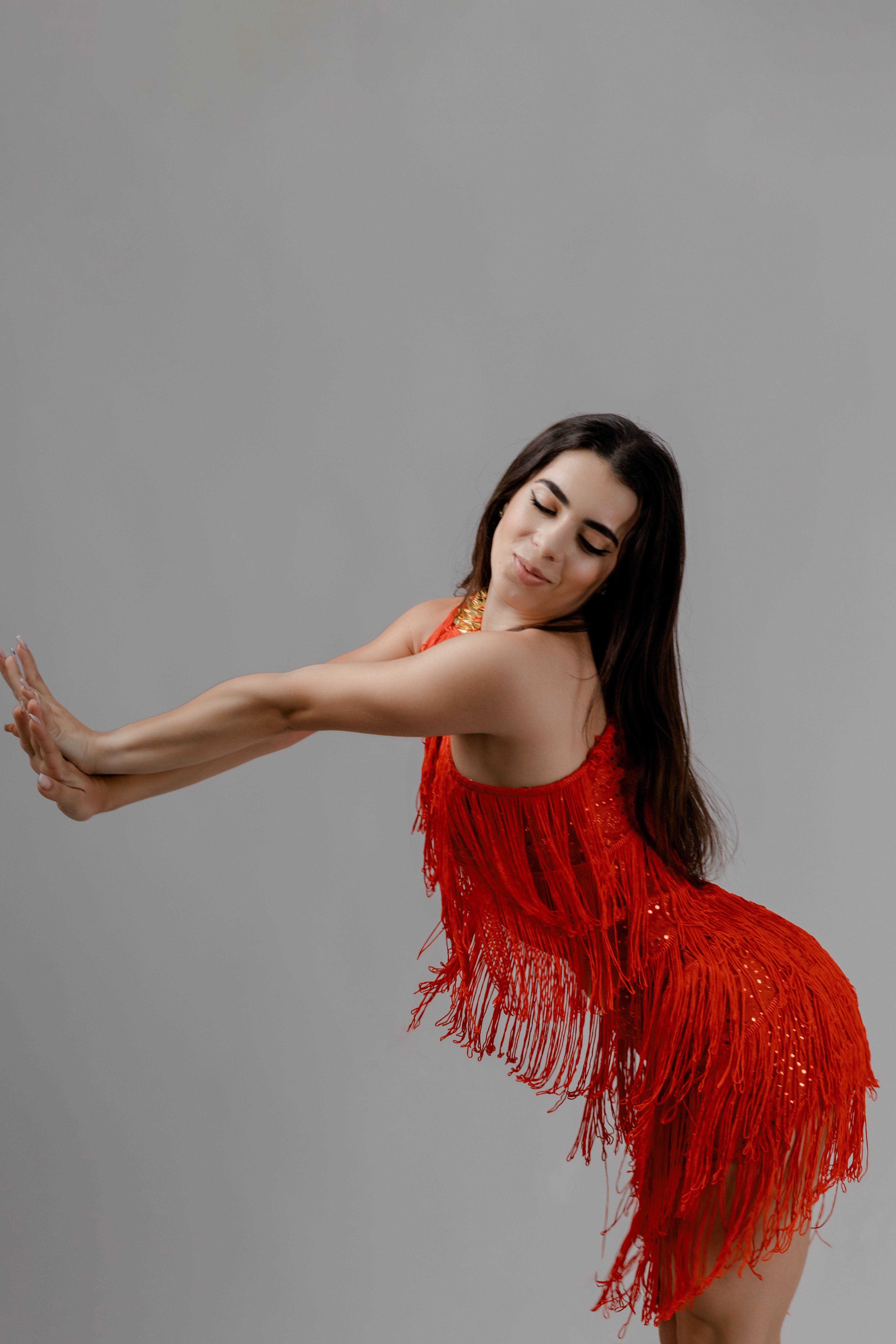 Elegant Woman in Red Fringe Dress Dancing · Free Stock Photo