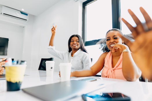 Diverse women engaged in a collaborative meeting at a modern office in Lagos, Nigeria.