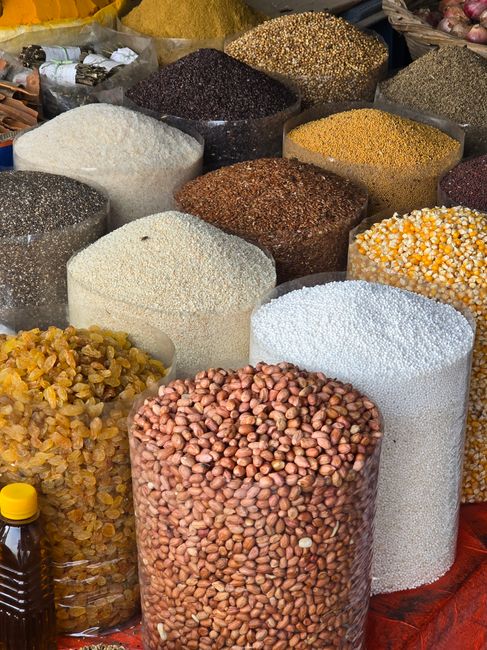 An array of grains and seeds on display in a Dhaka market, showcasing diverse textures and colors. - Finding the Best Platforms for Buying Dry Fruits
