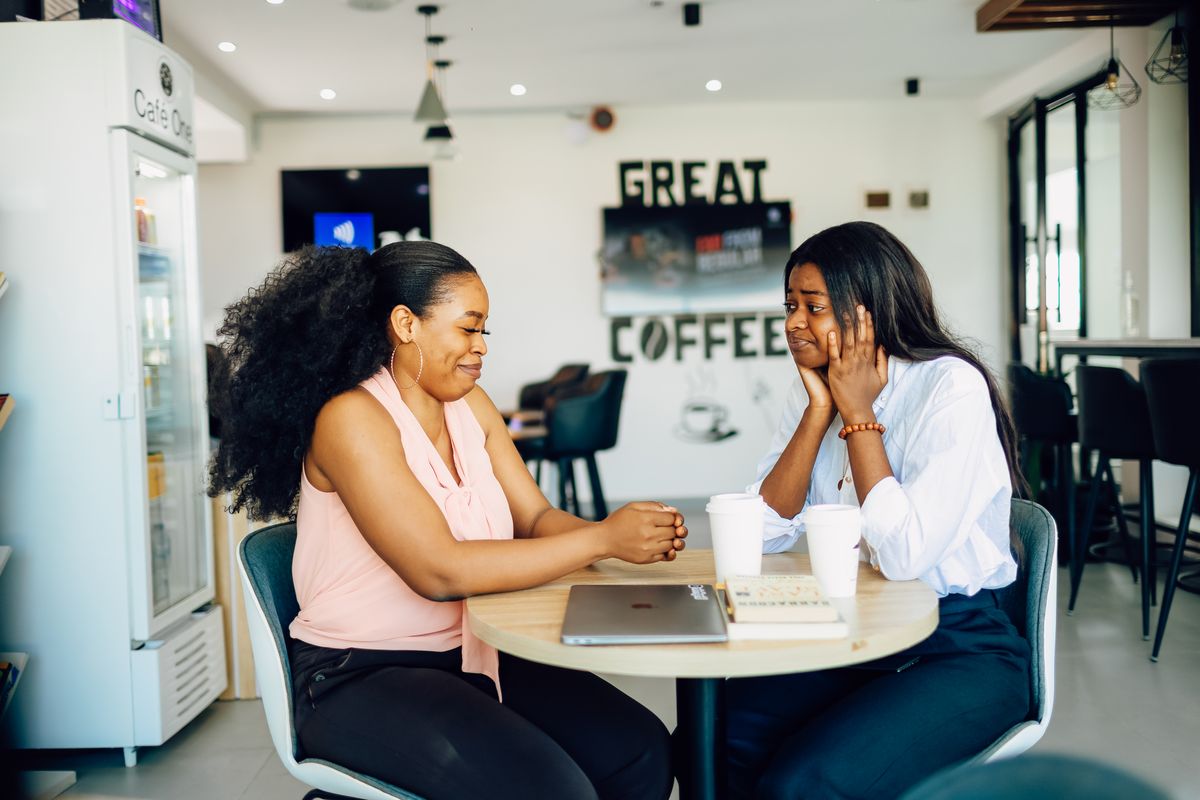 Two women in conversation at a coffee shop in Lagos, Nigeria