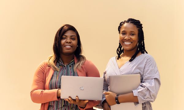 Businesswomen working on laptops in a modern office