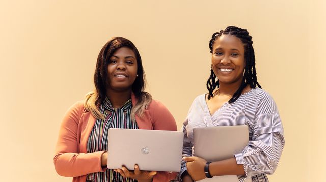 Businesswomen working on laptops in a modern office