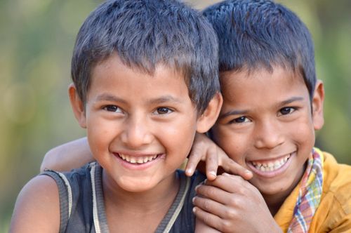 Free Two happy children smiling and embracing outdoors, symbolizing friendship and joy. Stock Photo