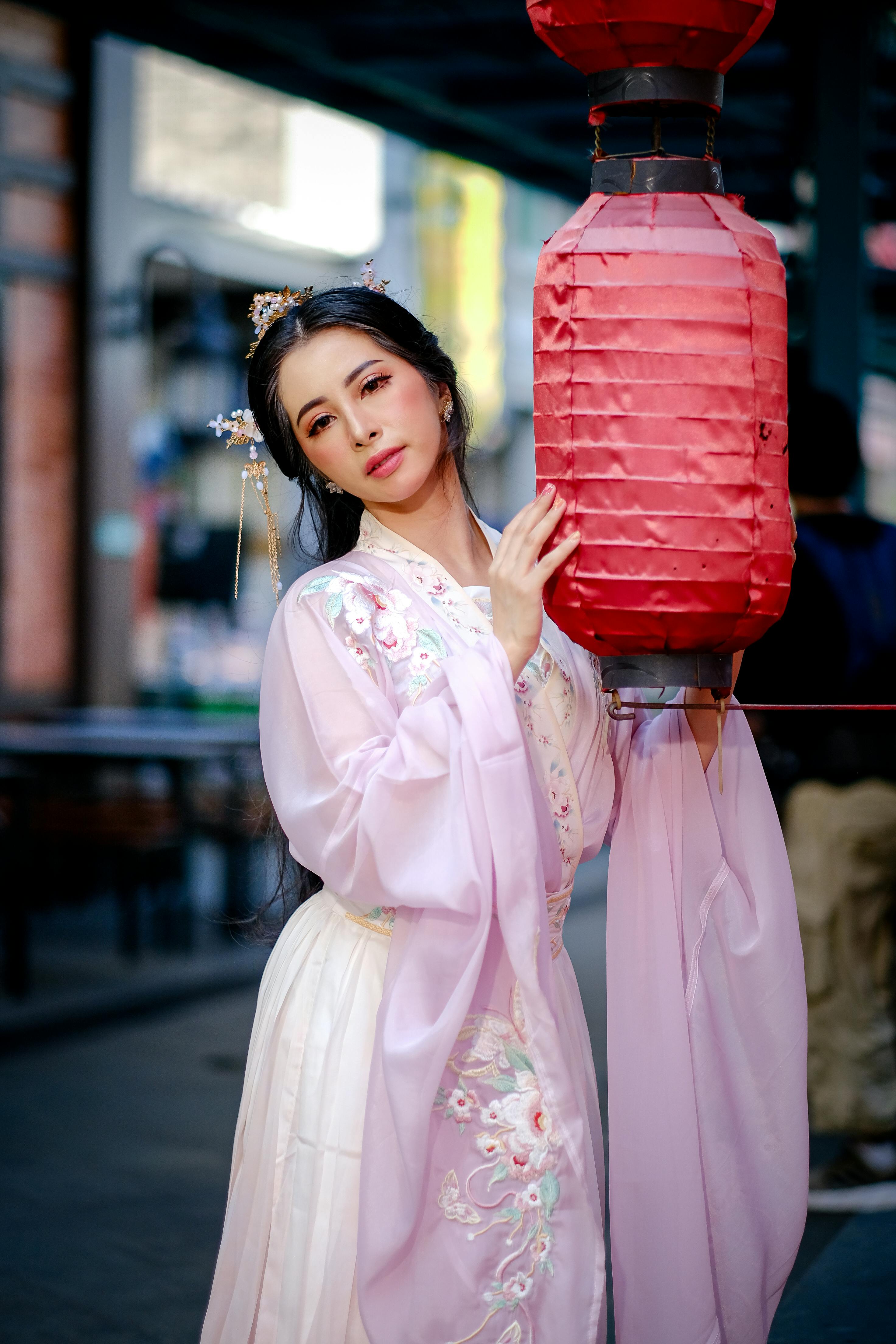 elegant woman in traditional hanfu with lantern