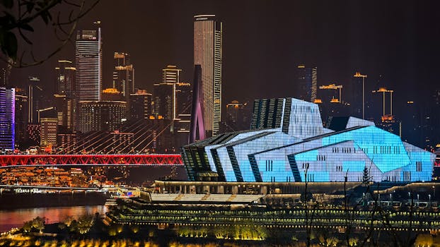 Vivid night scene of Chongqing featuring modern architecture and illuminated skyline.