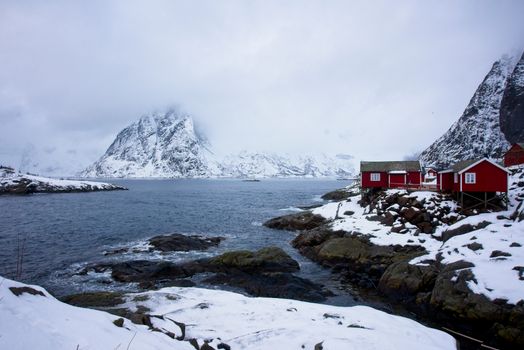 Stunning winter landscape featuring red cottages in Hamnøy, Lofoten Islands, Norway.