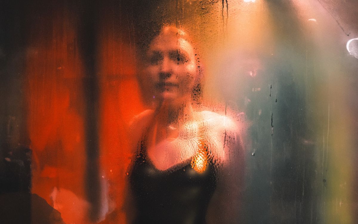Abstract portrait of a person behind a steamy glass, creating a cinematic feel.