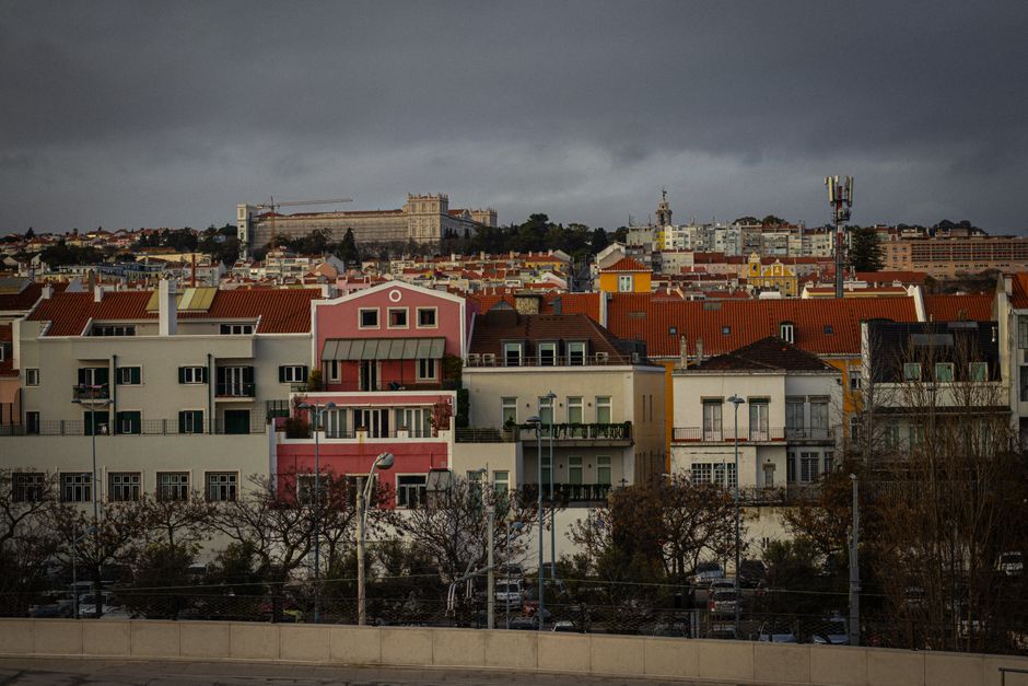 Scenic view of Lisbon's colorful rooftops under an overcast sky, showcasing the city's architectural charm.