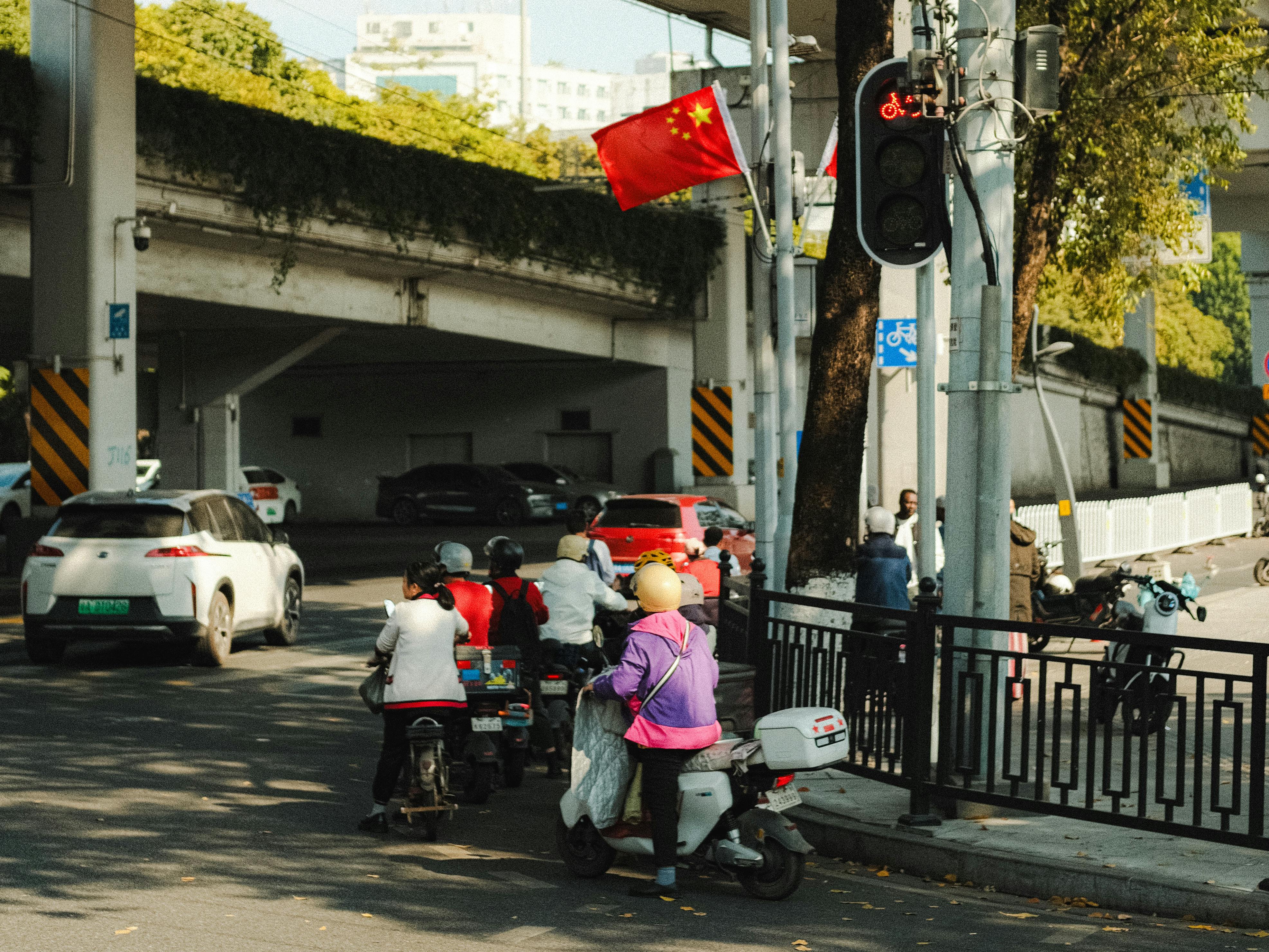 urban street scene with mopeds and traffic light