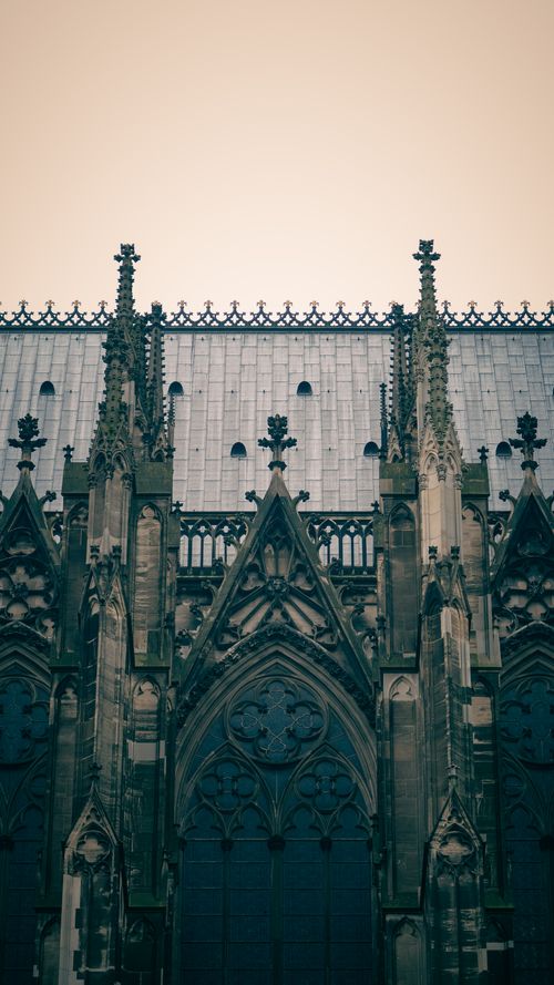 Free Intricate Gothic architecture of a cathedral facade with ornate spires and detailing. Stock Photo