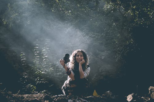 Sitting Woman Holding Camera