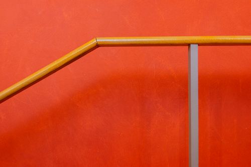 Free Abstract photo of a wooden railing against an orange background. Stock Photo