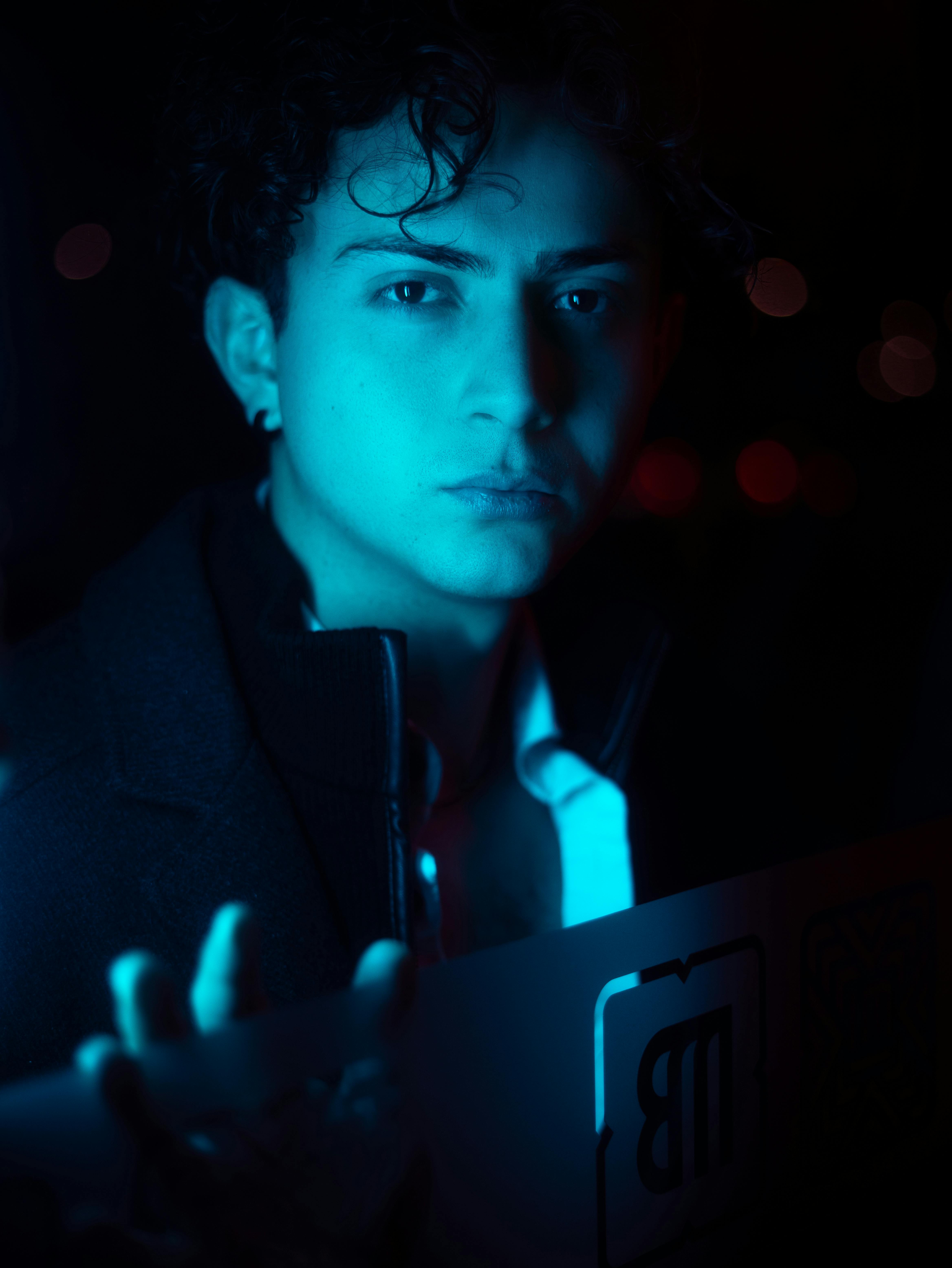 moody portrait of a man in blue neon light
