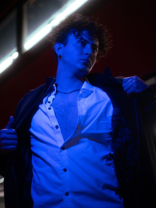 Free Dramatic portrait of a man in Mexico City with blue lighting and urban backdrop. Stock Photo