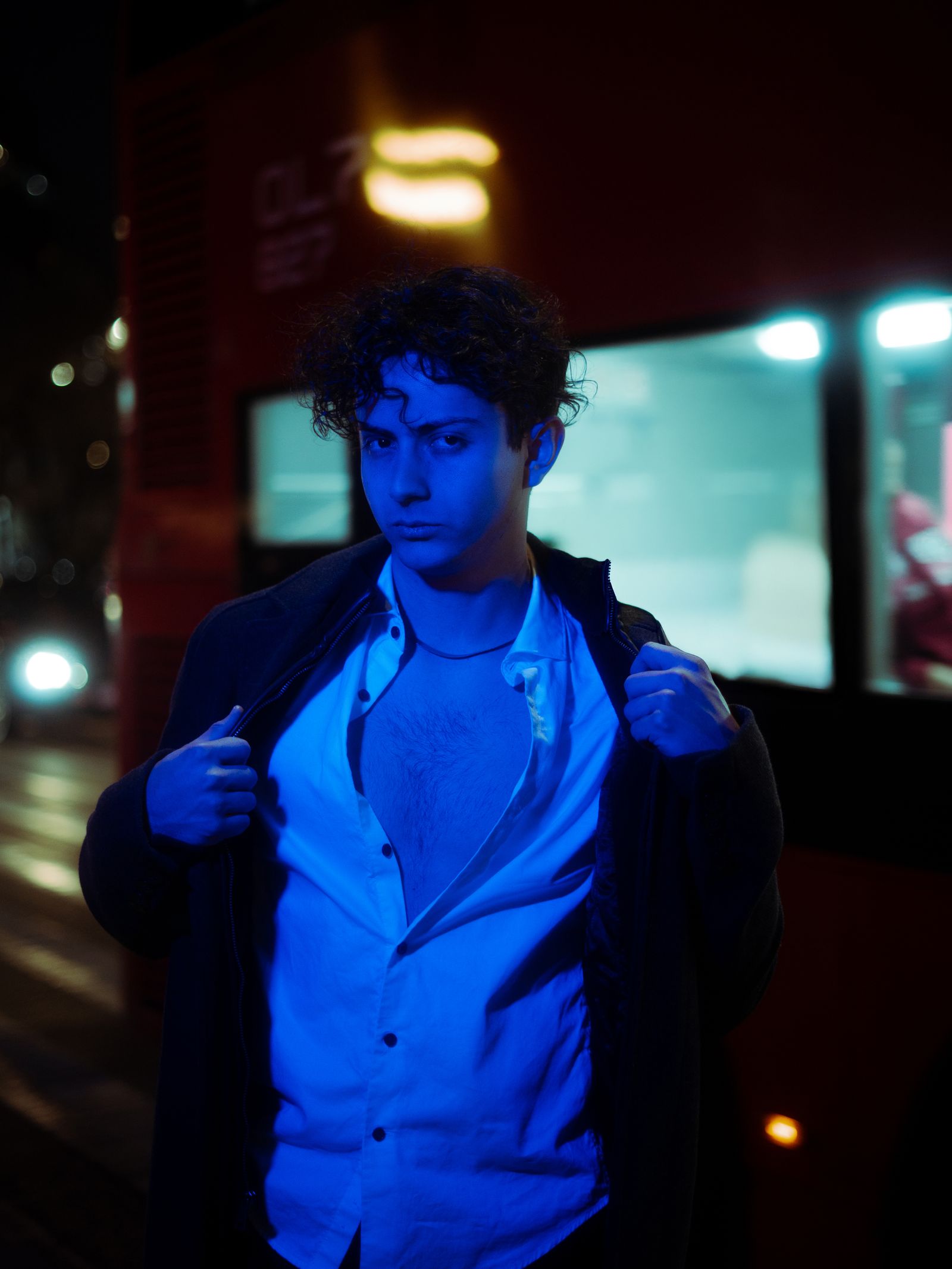 Cinematic warm-graded night portrait of a man on a city street