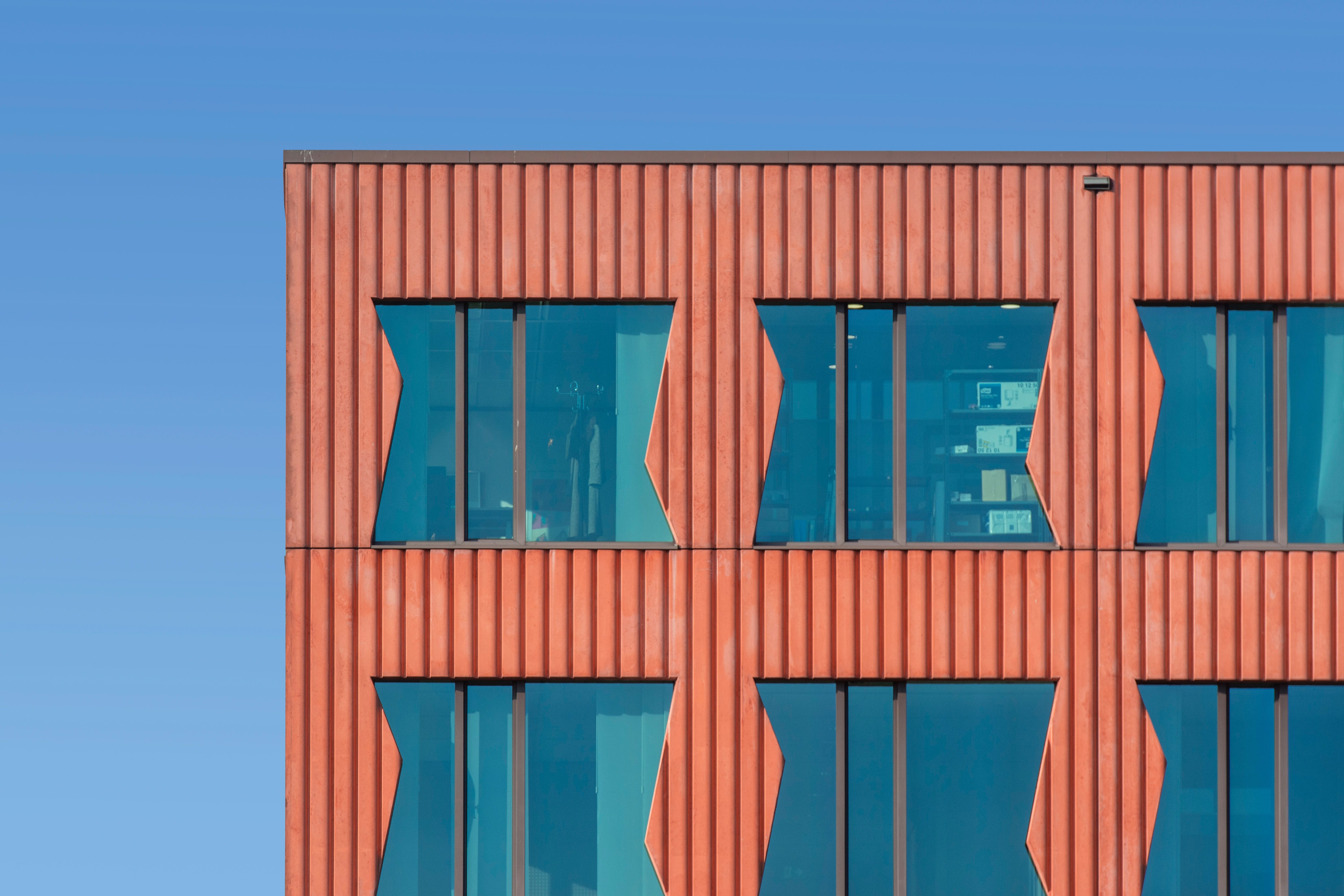 Modern Building Facade with Geometric Windows · Free Stock Photo