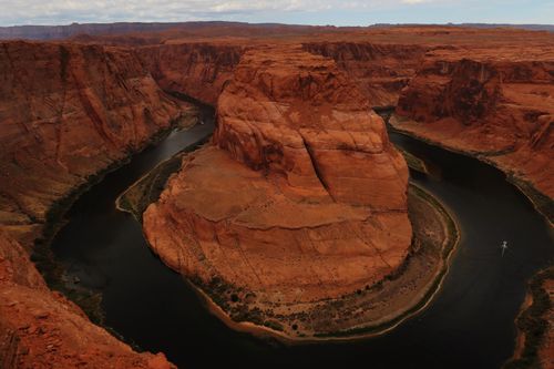 Free Dramatic aerial view of Horseshoe Bend, a striking rock formation in Arizona's desert. Stock Photo